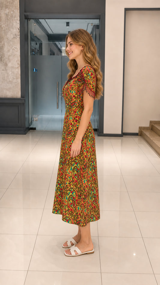 Side profile view of Mustard Yellow paisley midi dress showing sleeve detail and A-line drape