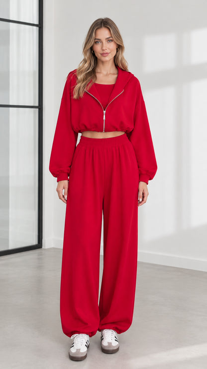 Front view of model wearing women's red 3-piece cropped zip hoodie and wide-leg lounge set