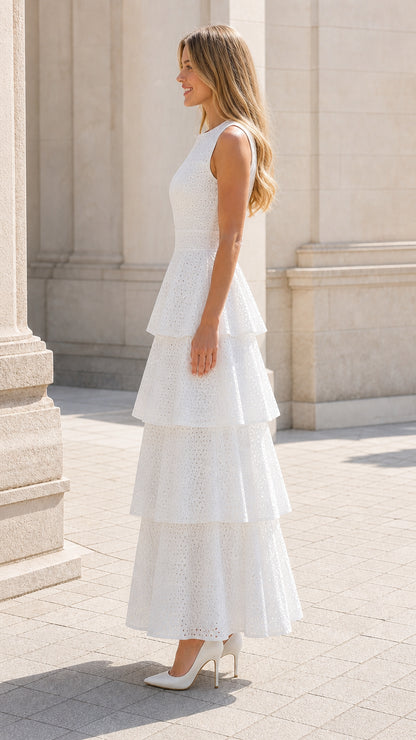 Side profile of woman in white tiered eyelet maxi dress