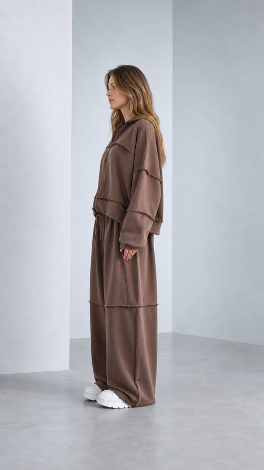 Side profile view of model wearing Chocolate Brown 2-piece lounge set with sneakers