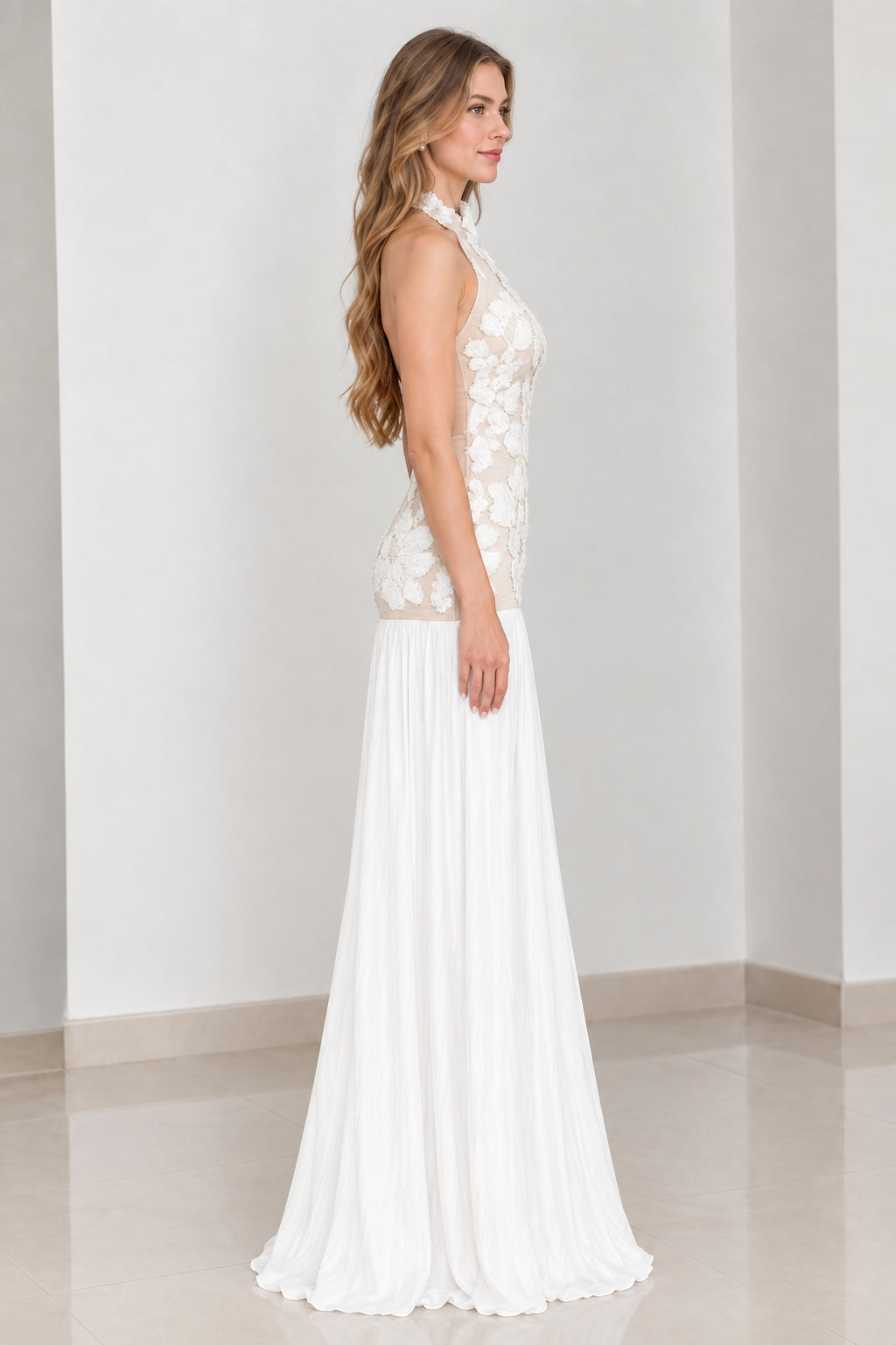 Side profile view of white halter neck formal pleated dress