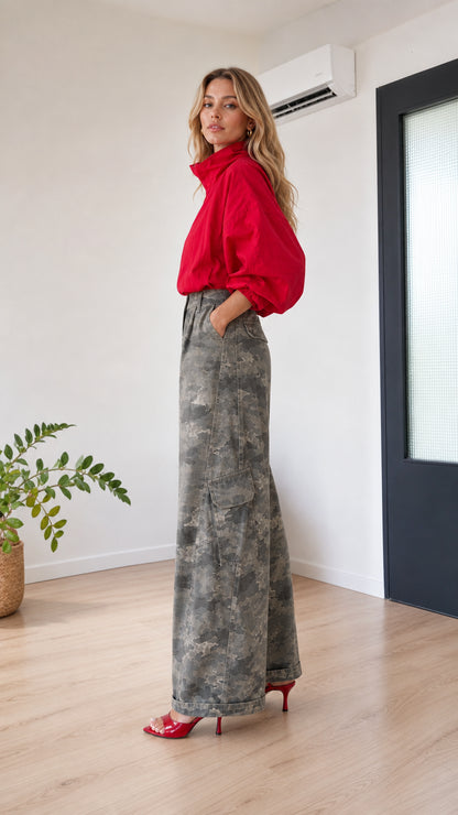 Side view of model showing wide-leg profile and side cargo pocket in grey camo