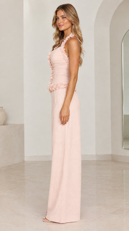 Side profile of model wearing Blush Pink halter wide-leg jumpsuit