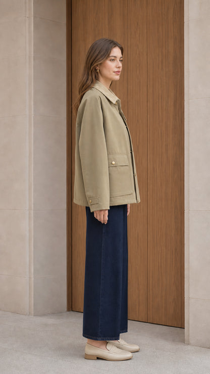 Side profile of woman in olive khaki snap front barn jacket