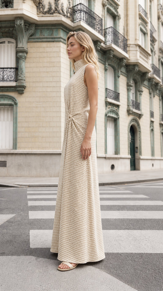 Side profile of model wearing beige gingham maxi dress