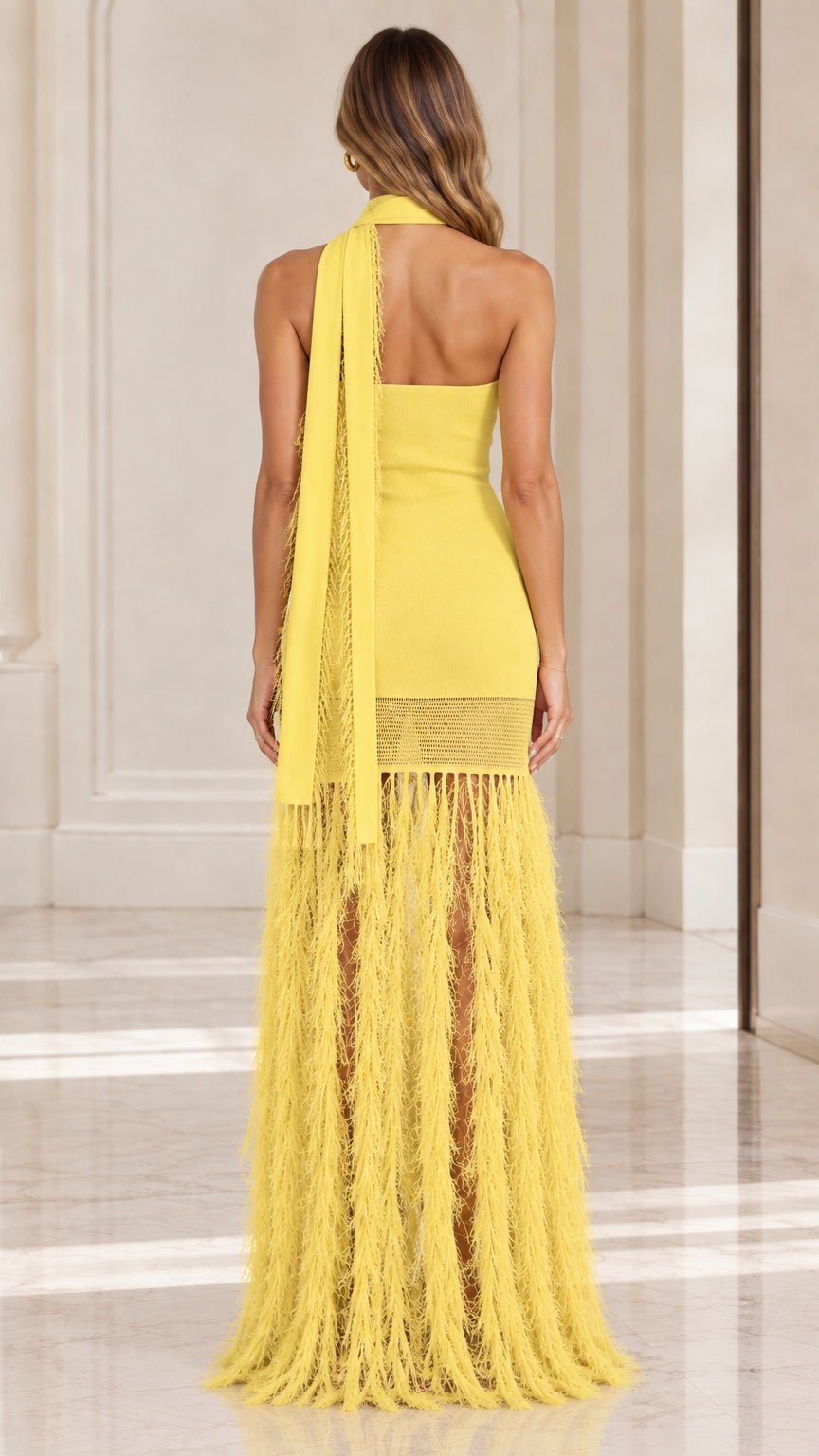 Back view of yellow bodycon knit dress showing open back and fringe scarf