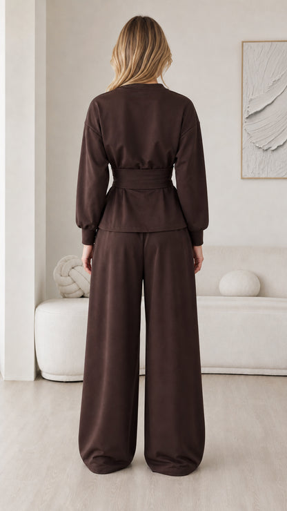 Back view of chocolate brown matching set showing relaxed cut and waist belt detail