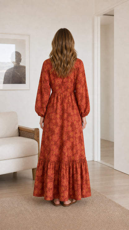 Back view of model wearing rust floral tiered maxi dress