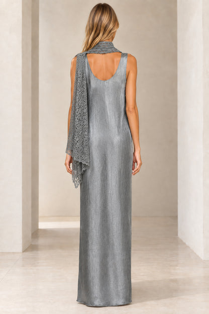 Back view of woman wearing silver shimmer maxi dress showing open back and draped scarf