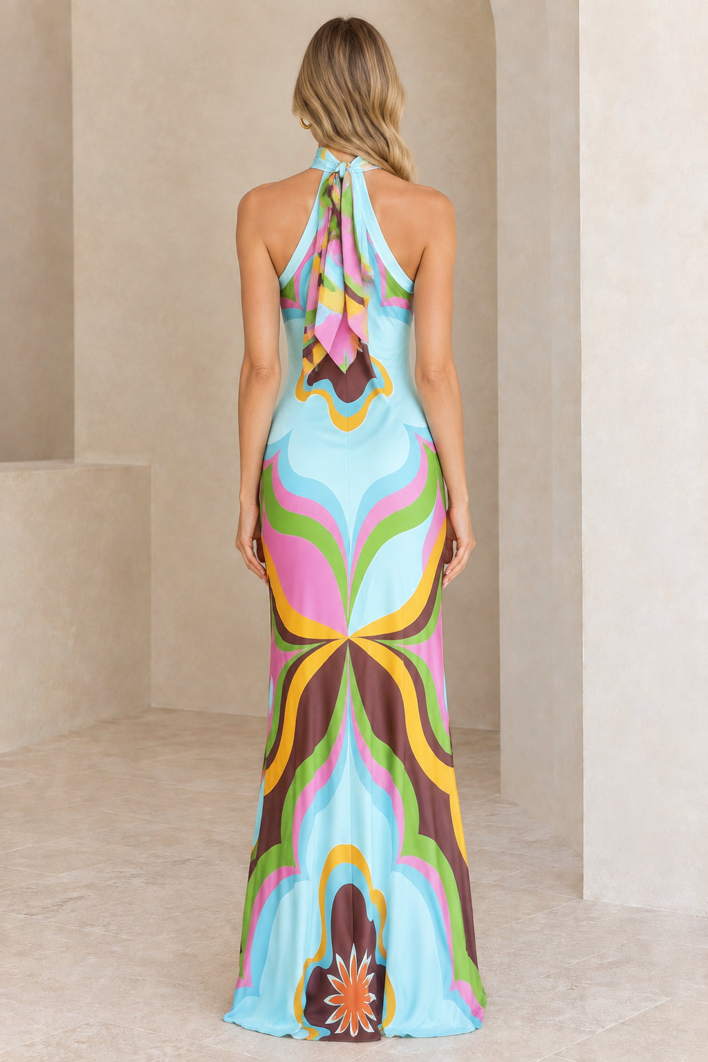 Back view of model in Light Blue halter gown showing self-tie back detail