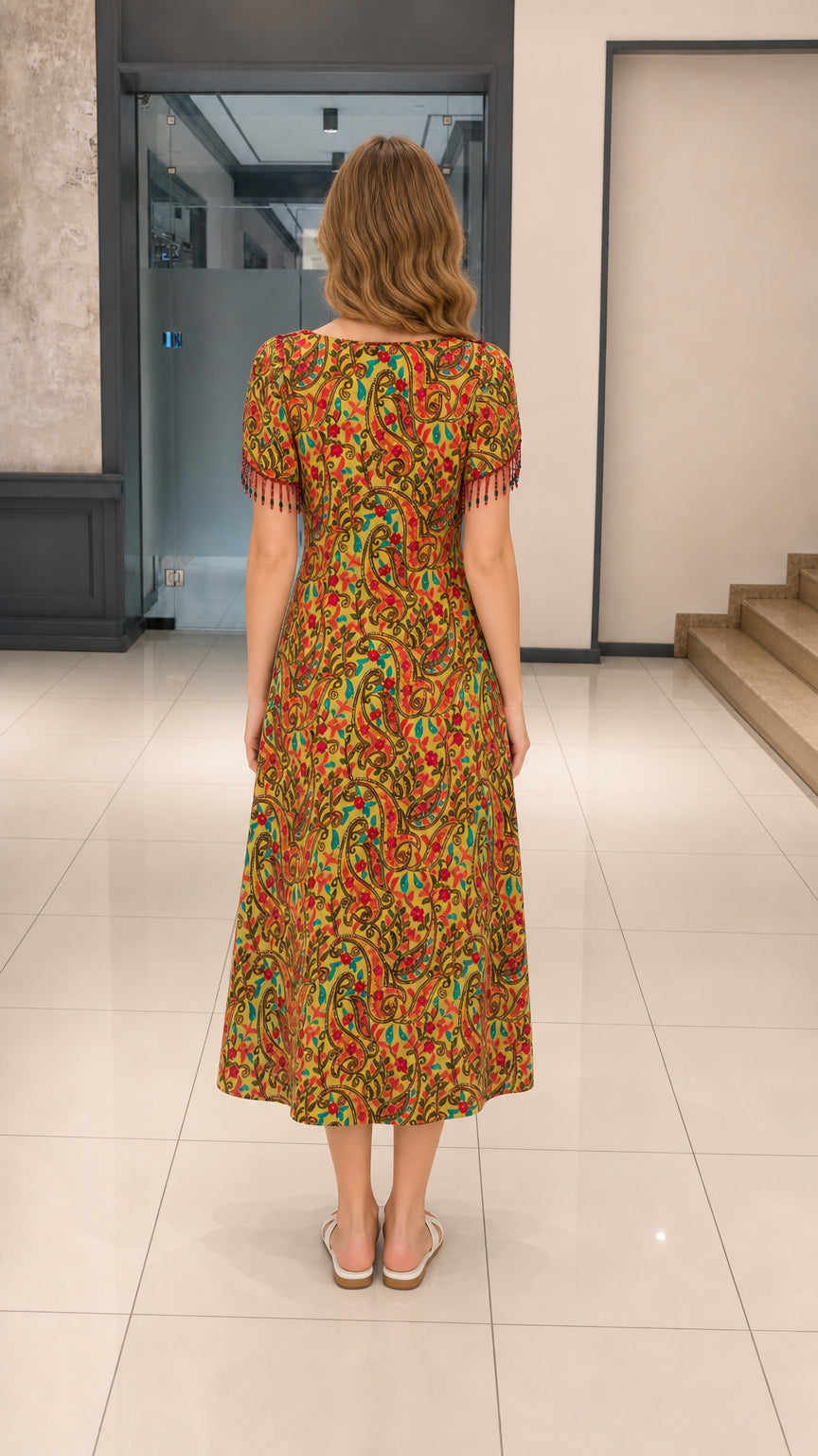 Back full view of woman wearing Mustard Yellow paisley midi dress