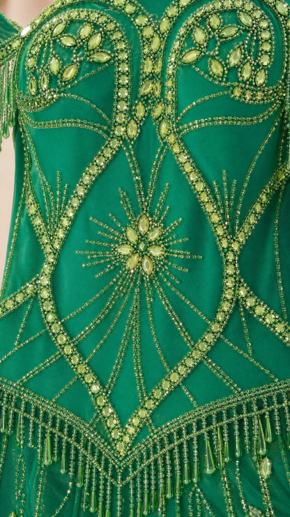 Close-up detail of the intricate green beadwork and crystal embellishments on the dress bodice