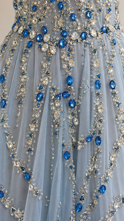 Close-up detail of rhinestone and crystal beadwork on tulle fabric