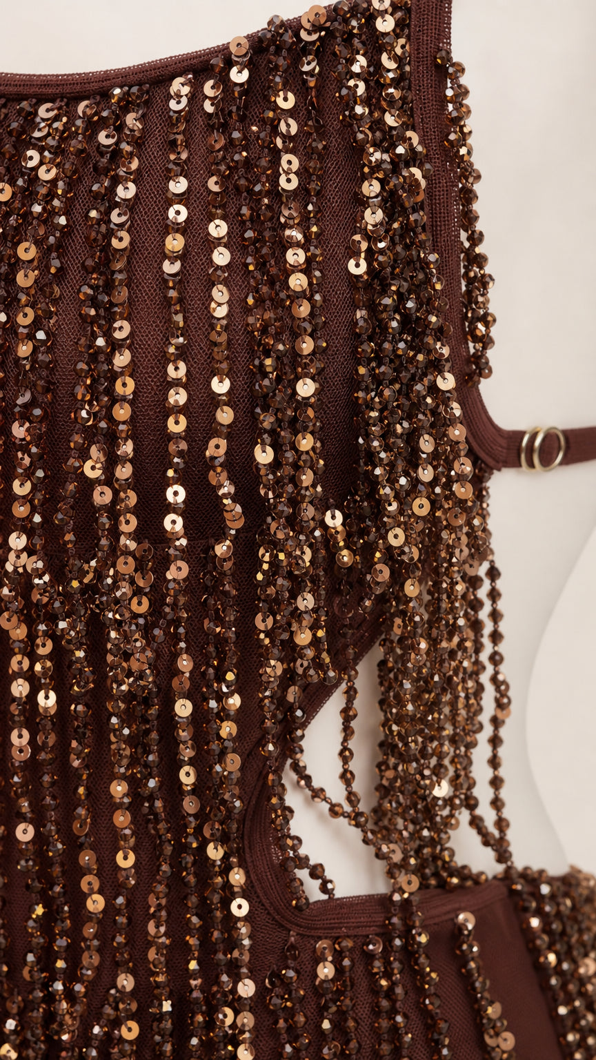 Close-up detail of shimmering brown sequins and fringe texture