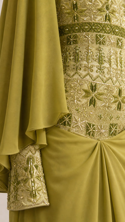 Close-up detail of green embroidered bodice and beaded cuff detail