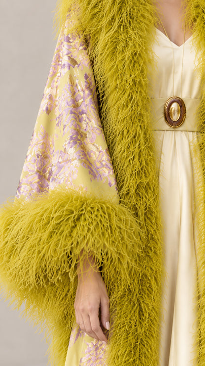 Close-up detail of chartreuse floral jacquard brocade and plush feather cuff