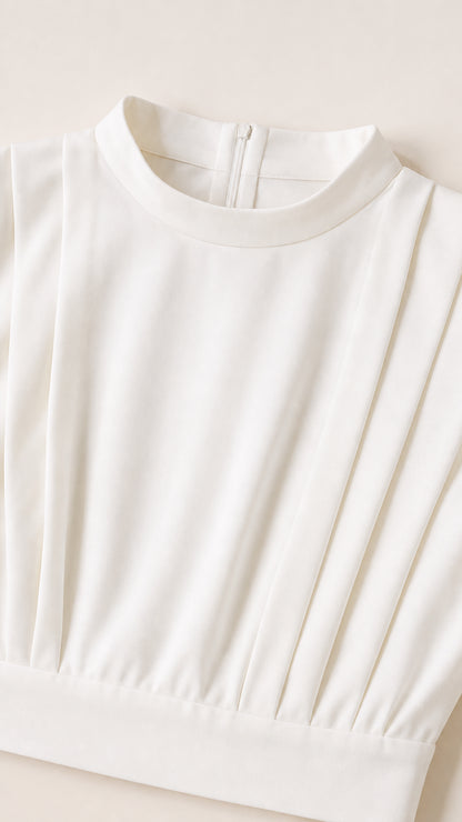 Close-up detail of white mock neckline with vertical pleating and clean finish