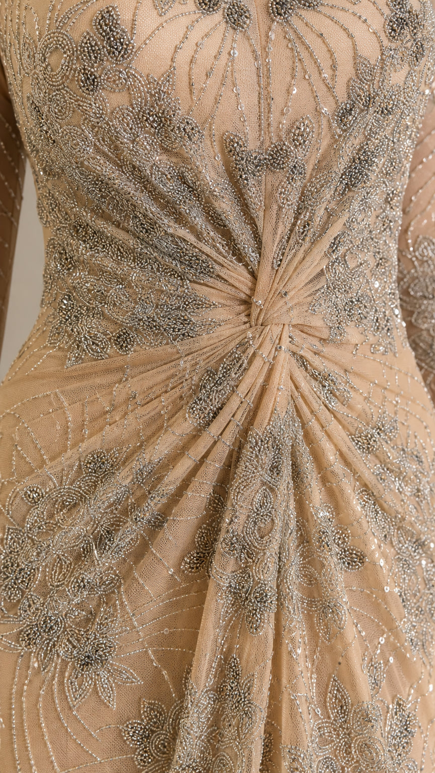 Close-up detail of intricate beadwork, sequins, and center-front twist gathering on bodice