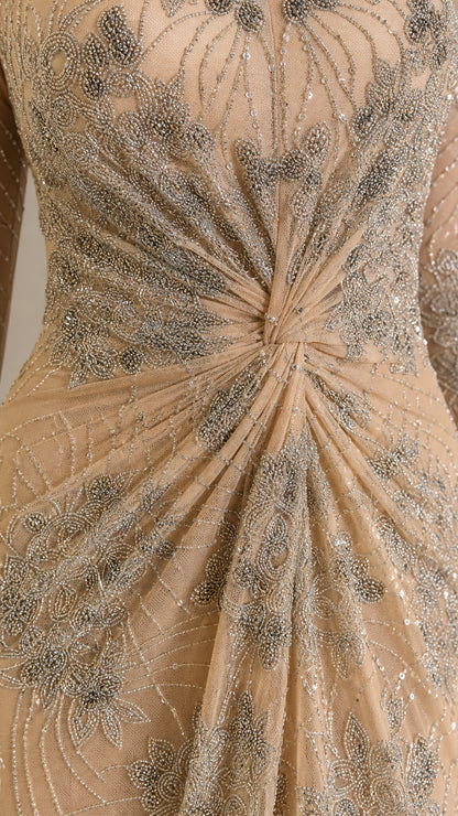 Close-up detail of intricate beadwork, sequins, and center-front twist gathering on bodice