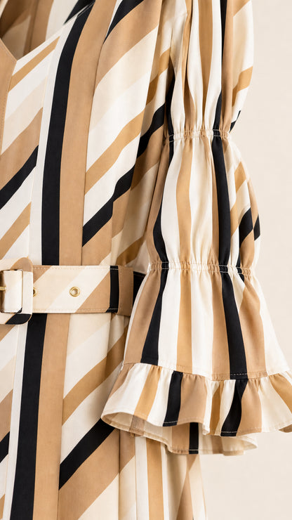 Close-up detail of belt and ruffled sleeve on striped midi dress