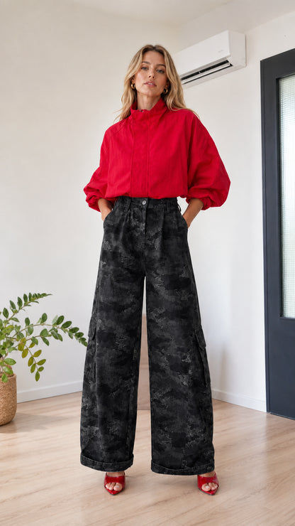 Model wearing black camo high-waisted wide-leg cargo pants with red top