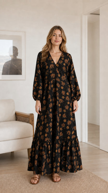Model wearing black floral print long sleeve tiered maxi dress