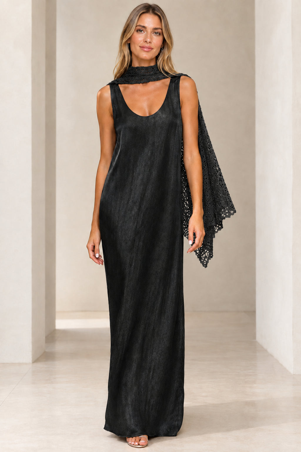 Front view of black shimmer sleeveless maxi dress with matching black crochet scarf