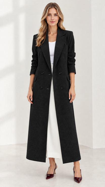 Front full-length view of woman wearing black tailored maxi double-breasted coat