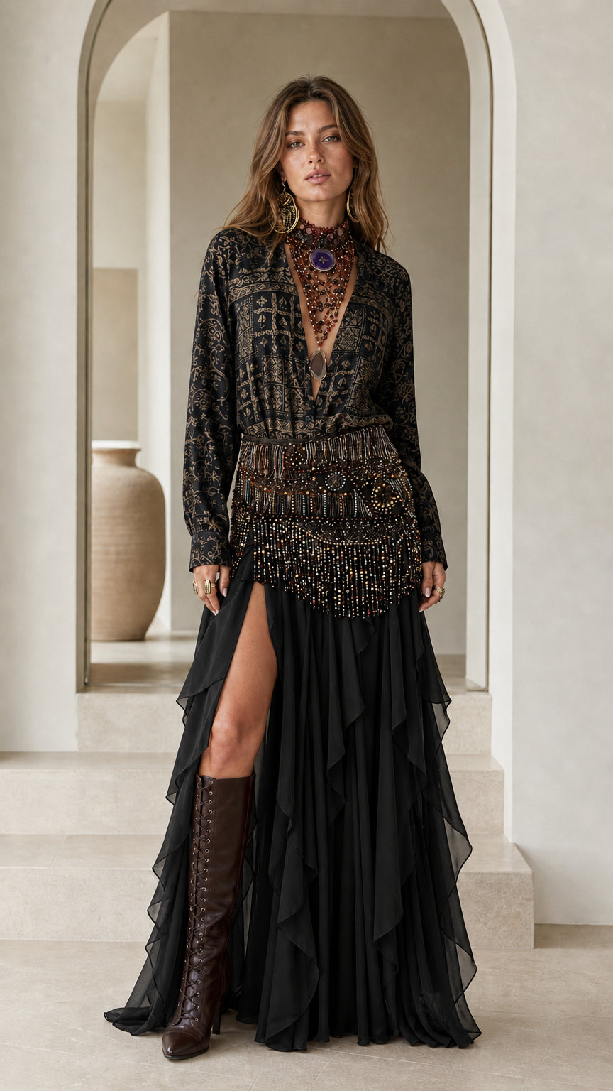 Model wearing black boho printed blouse and tiered ruffle skirt set