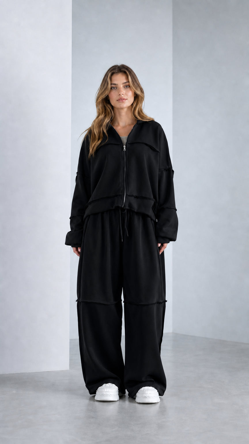 Full-length studio shot of model wearing Classic Black wide-leg 2-piece tracksuit