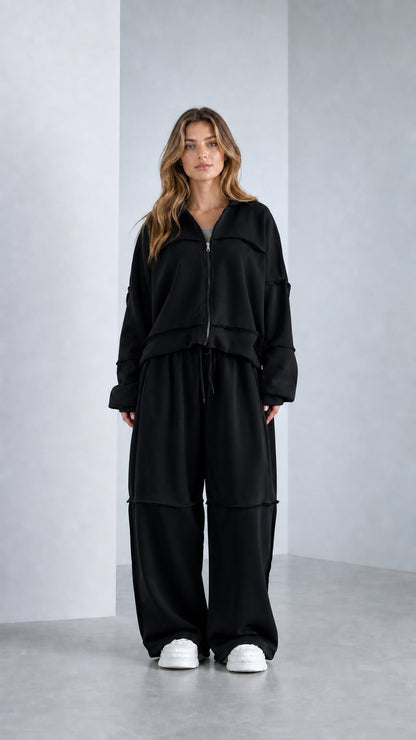 Full-length studio shot of model wearing Classic Black wide-leg 2-piece tracksuit