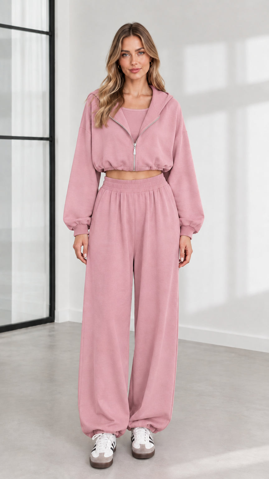 Front view of model wearing dusty pink 3-piece cropped zip hoodie and wide-leg lounge set