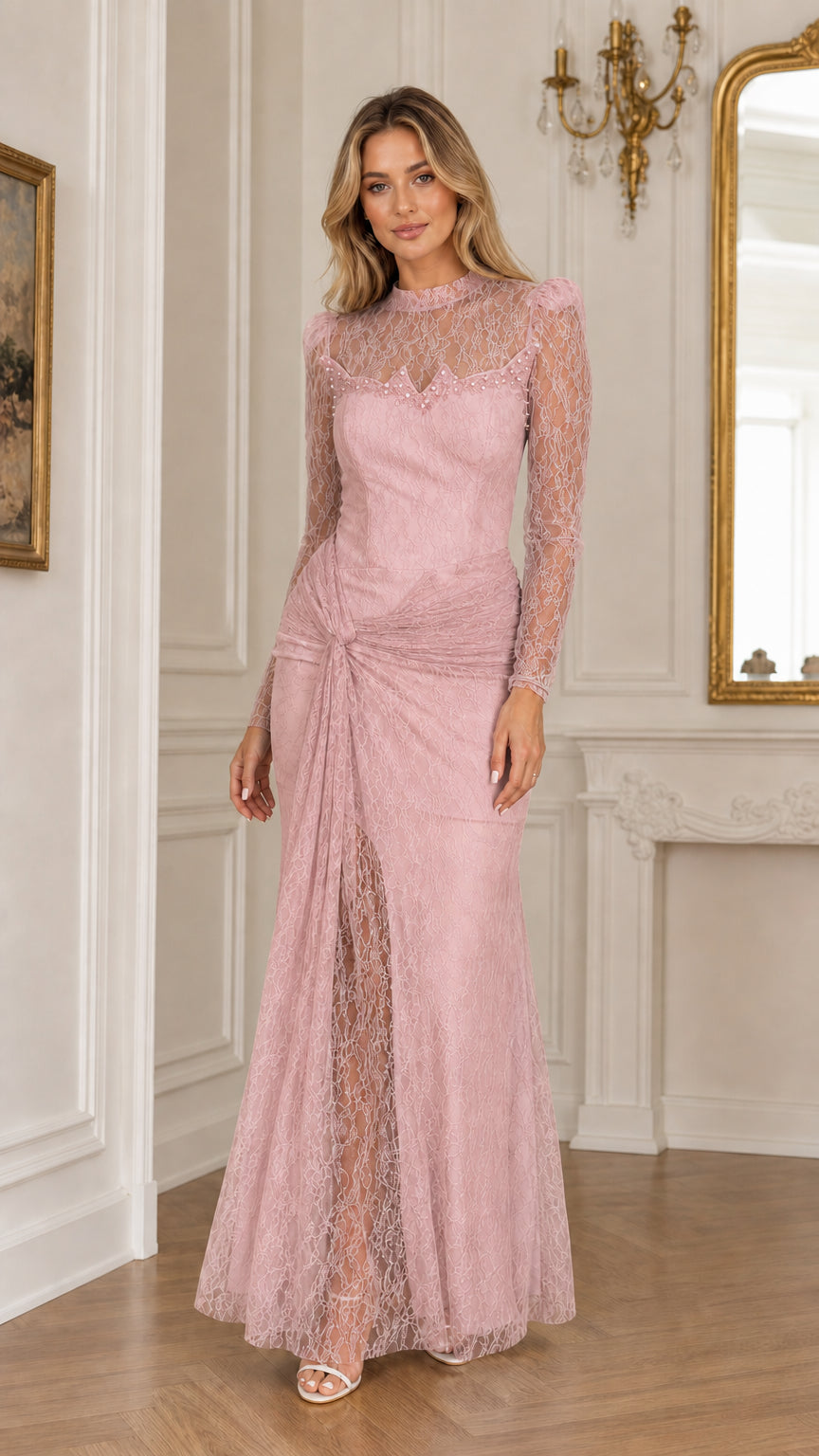 Full front view of a woman wearing a dusty pink long sleeve lace evening gown with front drape slit