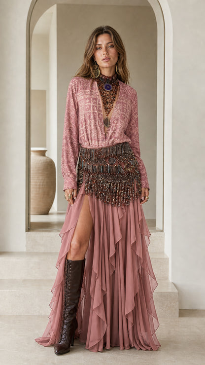 Model wearing pink boho printed blouse and tiered ruffle skirt set