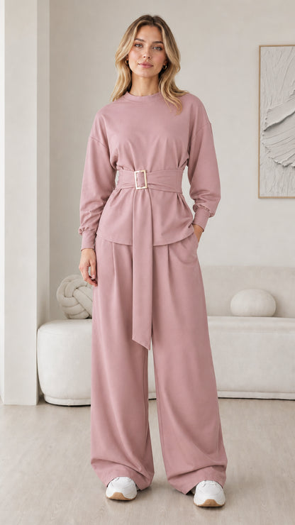 Model wearing dusty pink long sleeve belted lounge top and wide leg trousers set