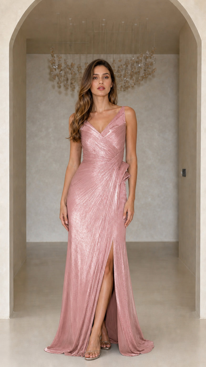 Model wearing blush pink metallic pleated formal maxi dress with side ruffle