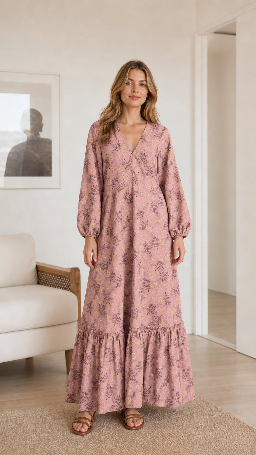 Model wearing dusty pink floral print long sleeve tiered maxi dress