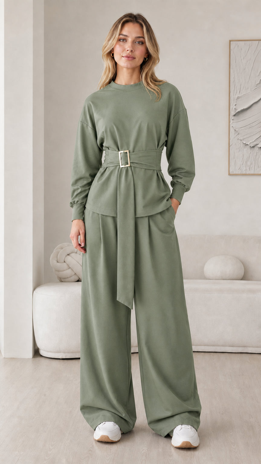 Model wearing sage green matching two-piece belted top and wide leg pants set