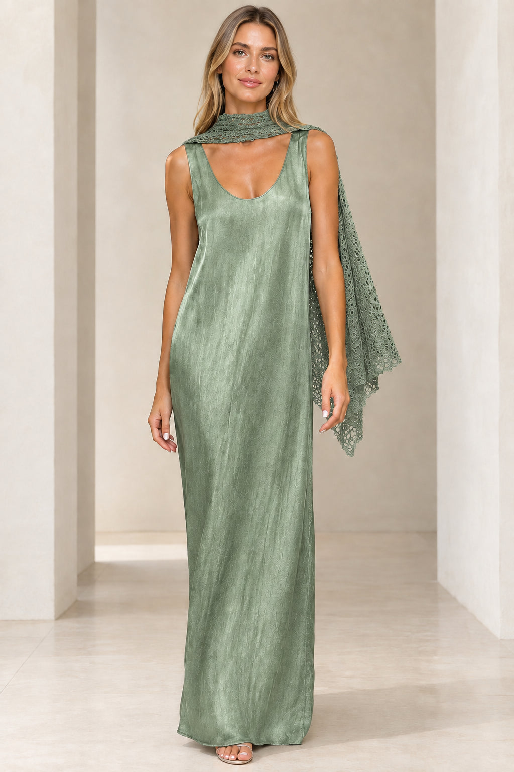 Front view of sage green shimmer sleeveless maxi dress with matching green crochet scarf