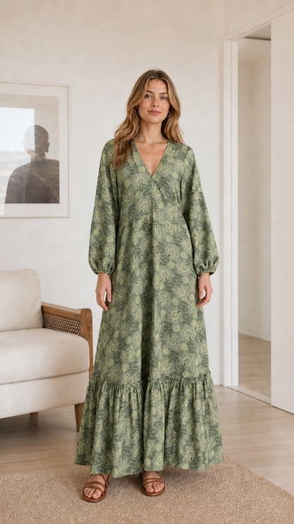 Model wearing sage green floral print long sleeve tiered maxi dress