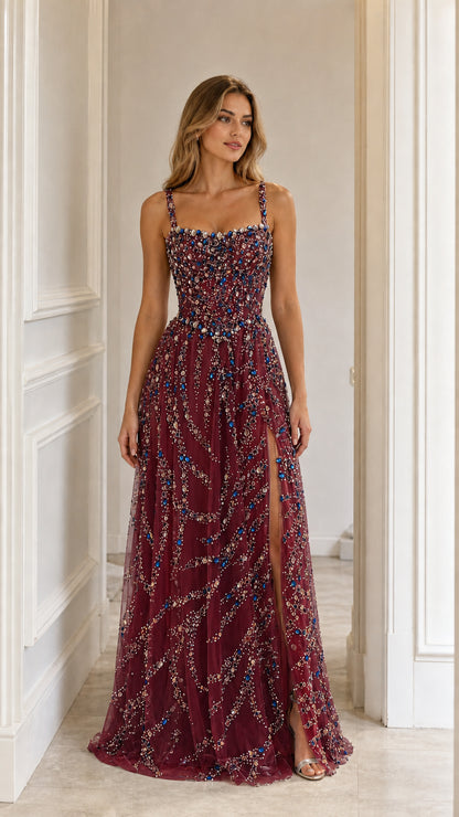 Front view of burgundy crystal embellished evening gown with high slit