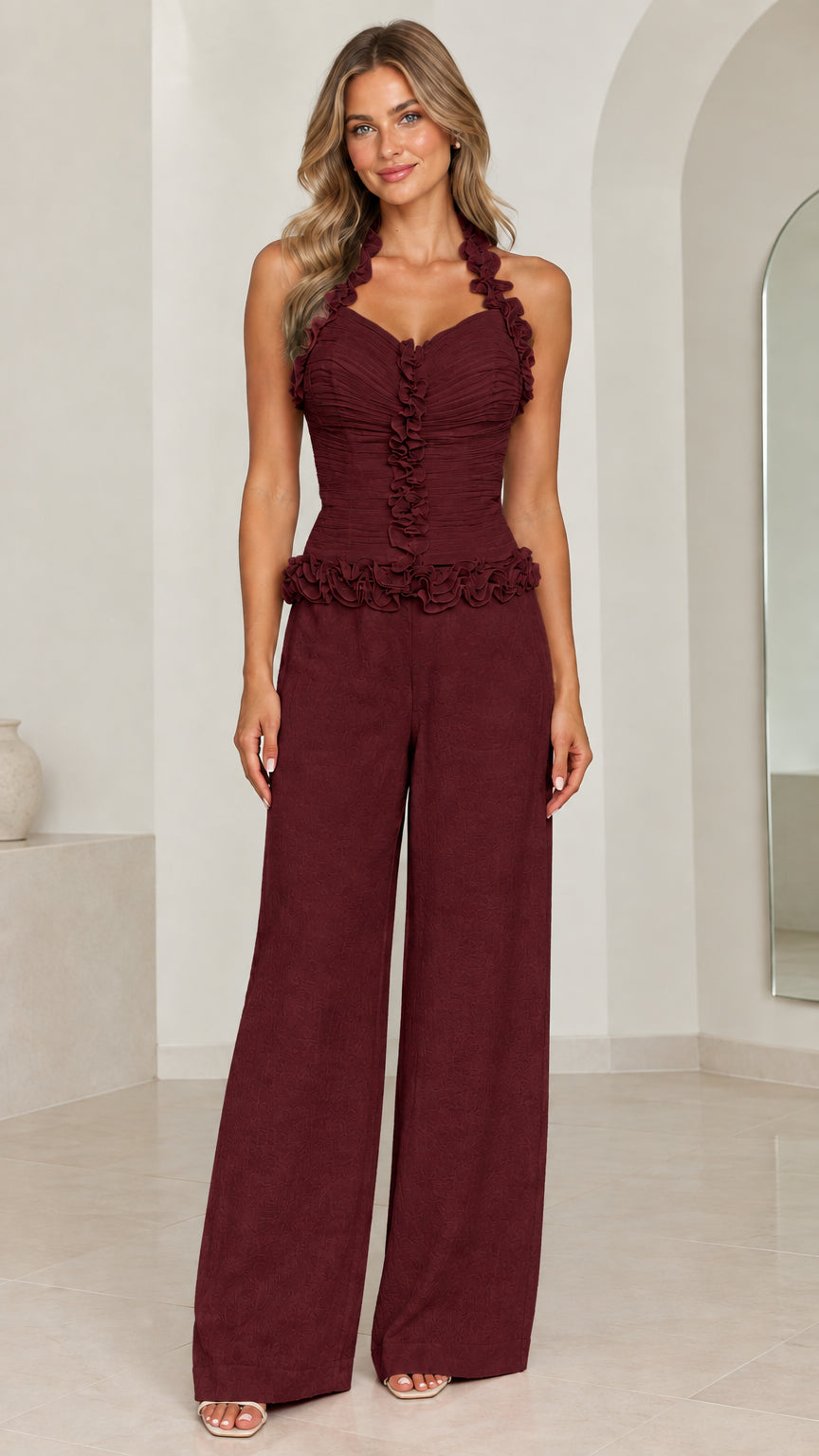 Front view of model wearing Burgundy ruffle halter wide-leg jumpsuit