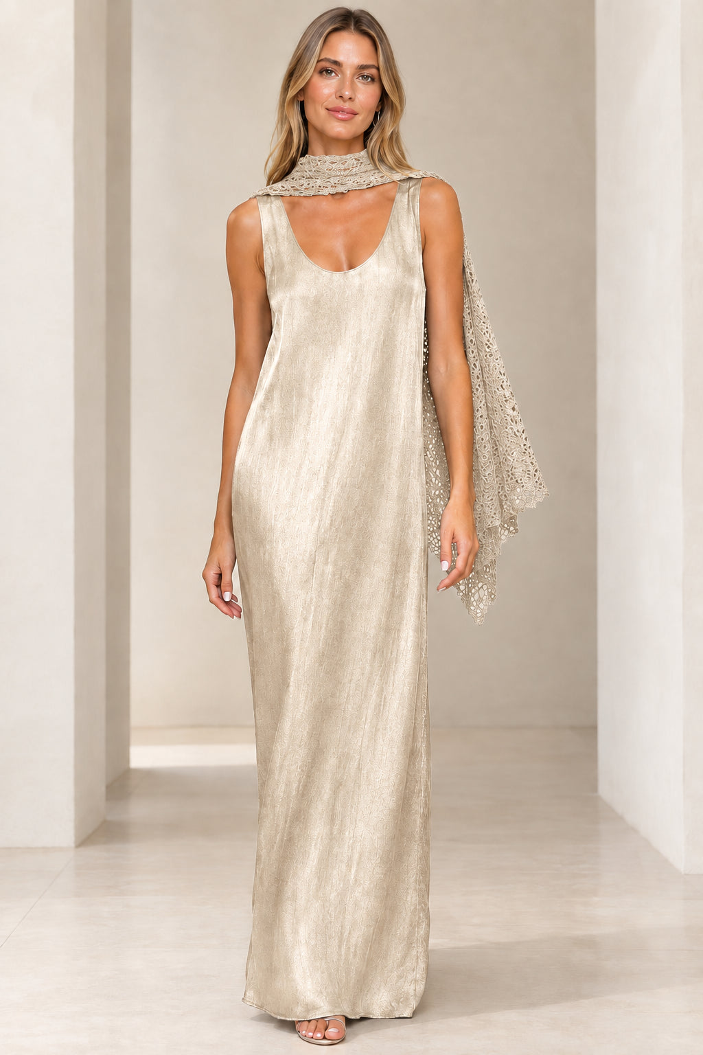 Front view of champagne gold shimmer sleeveless maxi dress with matching beige crochet scarf