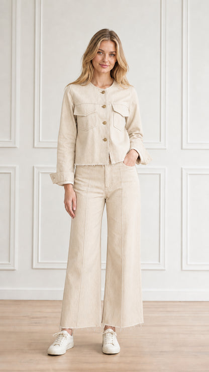 Model wearing cream off-white denim two-piece jacket and pants set