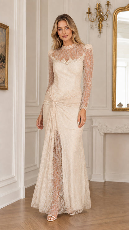 Full front view of a woman wearing a champagne ivory long sleeve lace evening gown